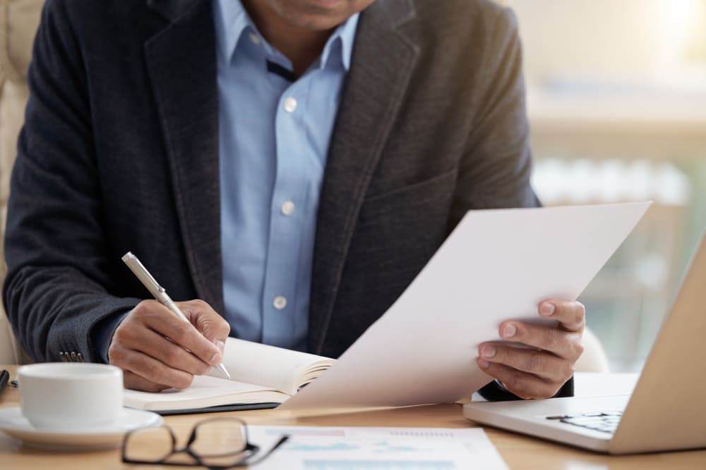 Homem vestindo terno realizando atividades profissionais após finalizar MBA em Compliance.